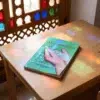El libro de la purificación para niños - Al Ghazali de Abu Hamid Al-Gazali (Algazel), sobre una mesa de madera con la sombra de una celosía