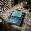 Libro 8 - Los modales de la recitación del Corán de Imam Al-Gazzali, sobre una mesa de madera con la sombra de una celosía