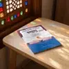 Prophet Yunus and the Whale de Ahmed Bermejo, sobre una mesa de madera con la sombra de una celosía