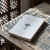 Ser musulmán - Una guía práctica de Asad Tarsin, sobre una mesa de madera con la sombra de una celosía